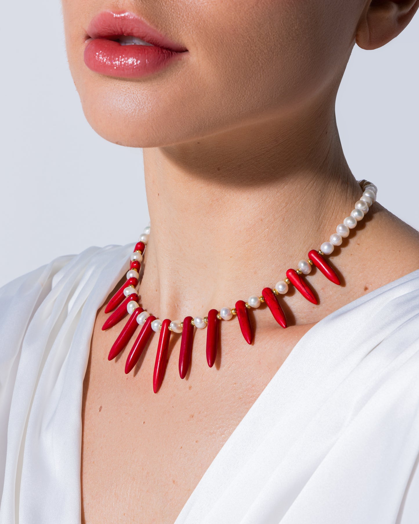 high-quality cultured pearl necklace adorned with elegant red triangle-shaped synthetic stones