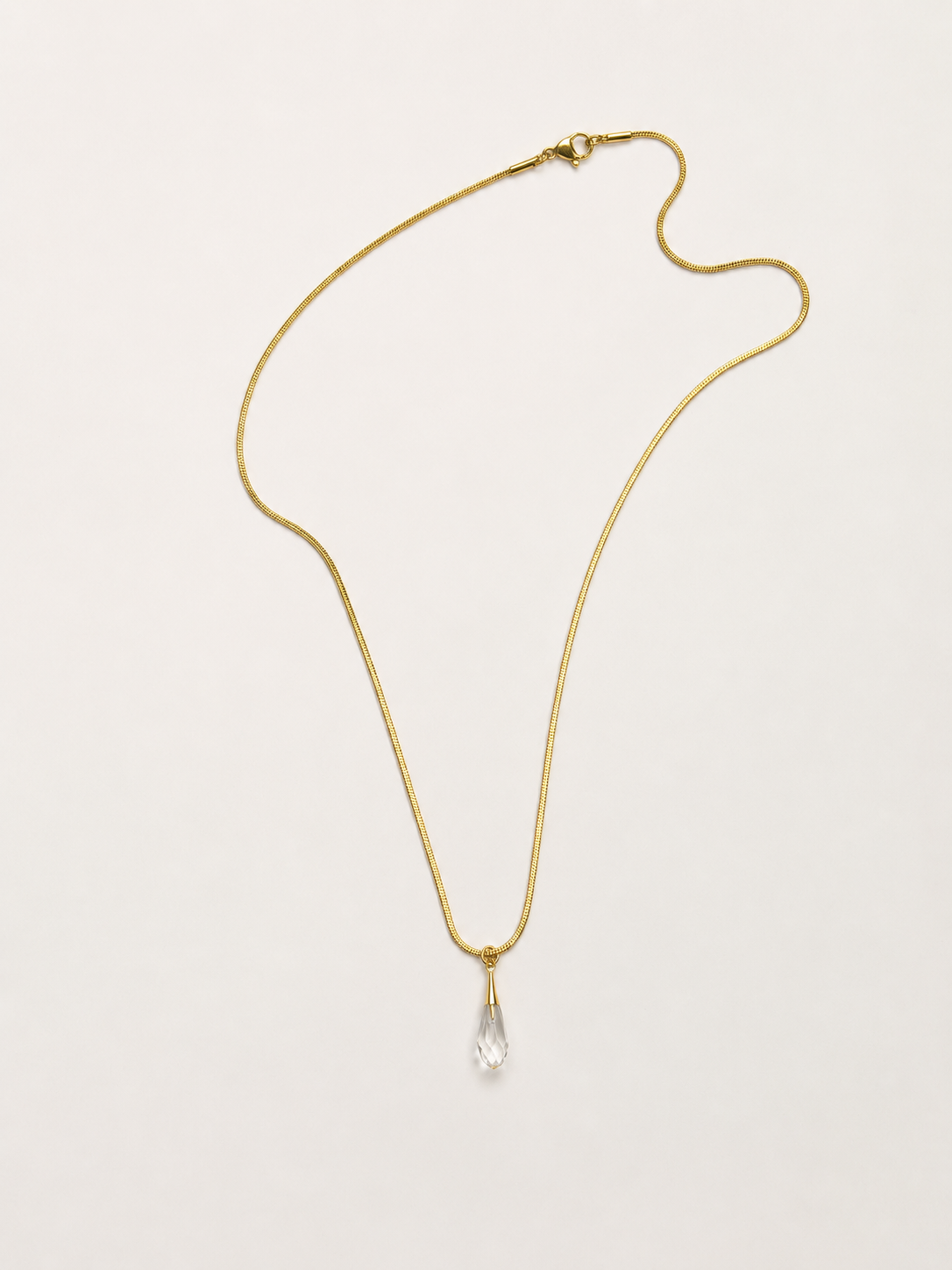 luxurious gold stainless steel necklace featuring a Swarovski crystal pendant.