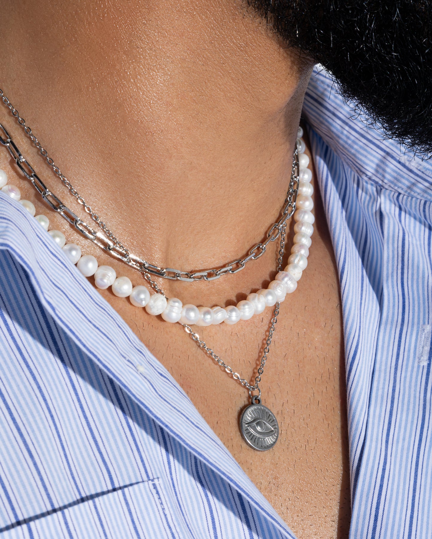 Silver-toned stainless steel necklace featuring an eye-shaped pendant