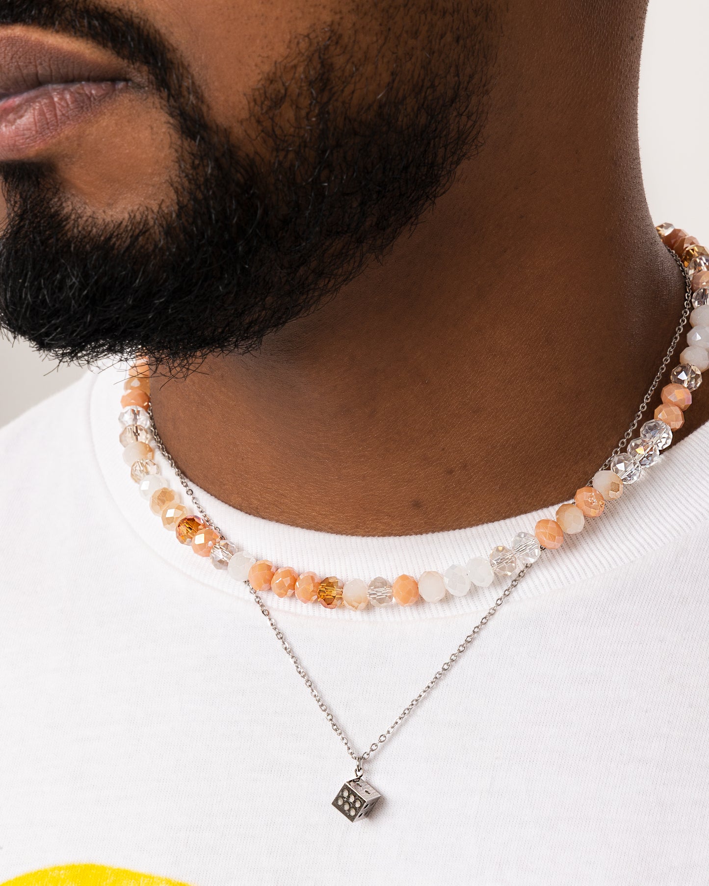 Stainless steel necklace featuring a dice pendant