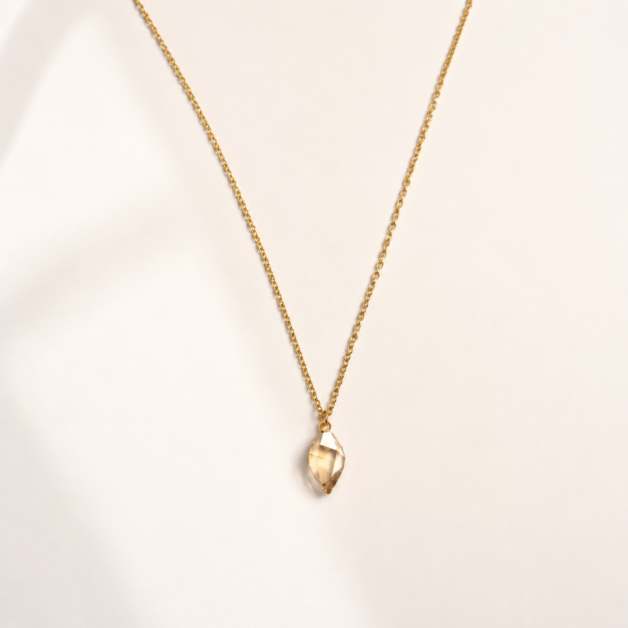 gold stainless steel necklace featuring a luxurious Swarovski crystal in a stunning Shadow Gold shade.