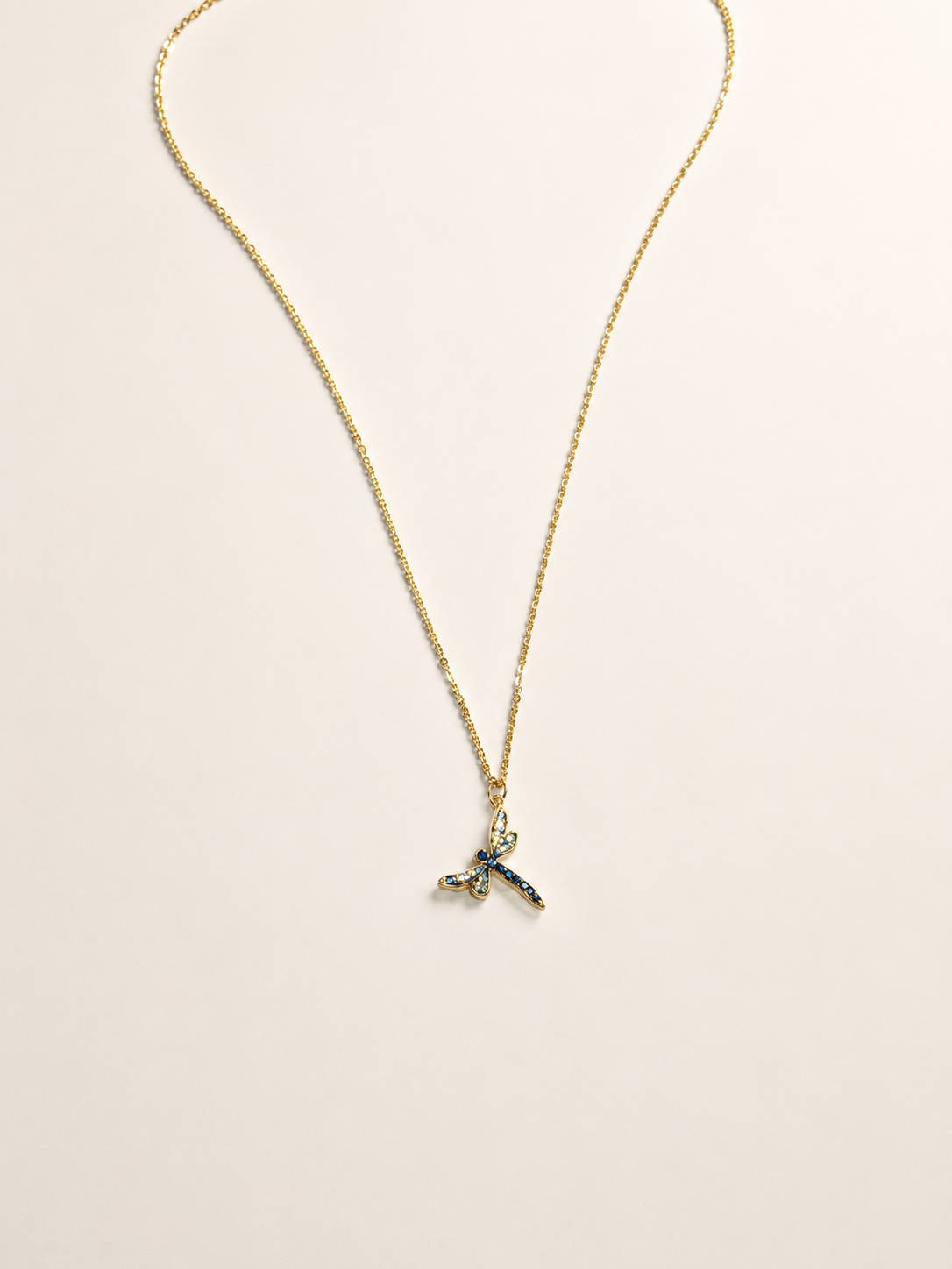 statement gold stainless steel necklace adorned with a Swarovski crystal dragonfly pendant.