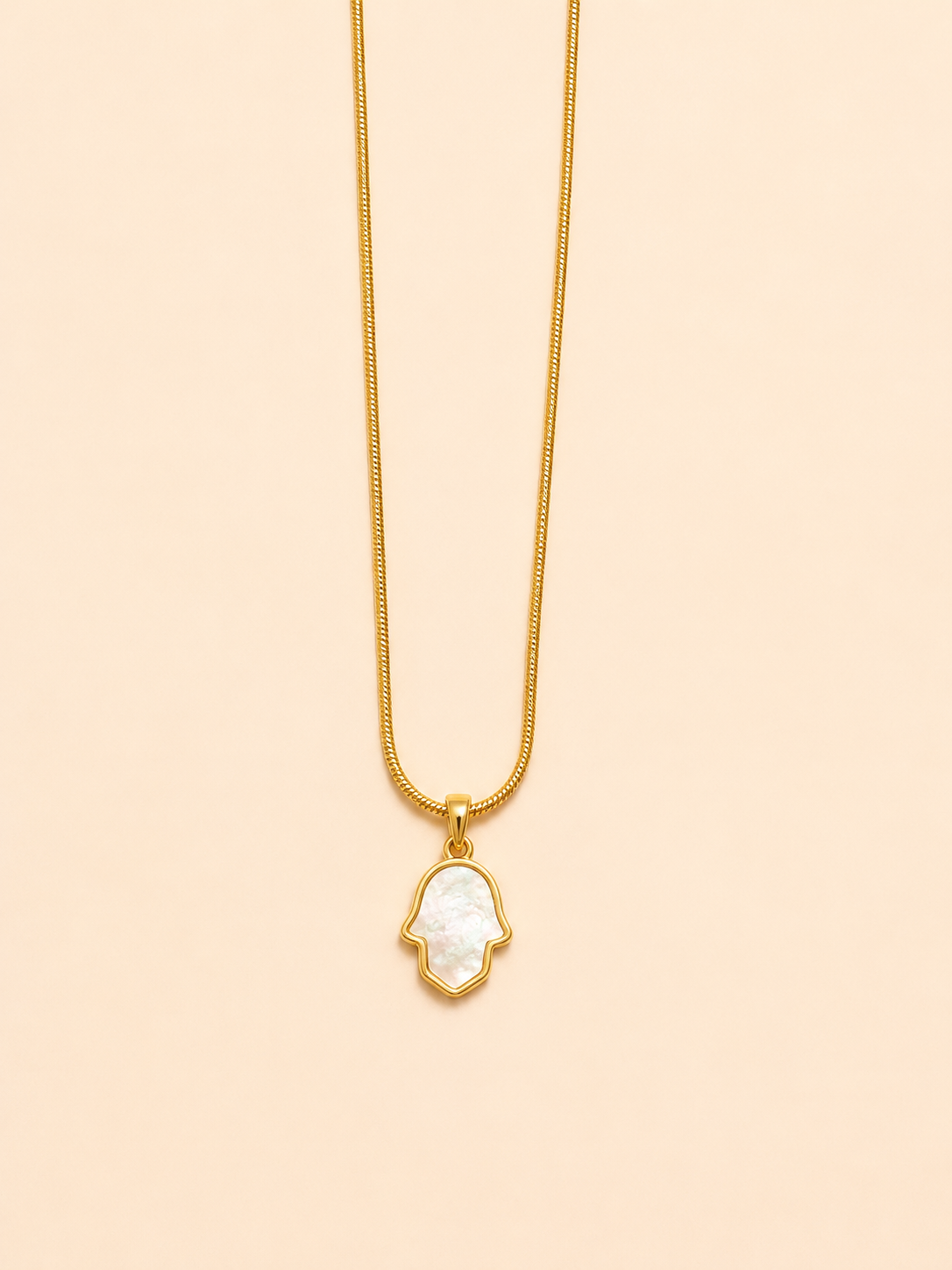 gold-plated stainless steel necklace featuring a hand-shaped pendant crafted with cultured pearls.