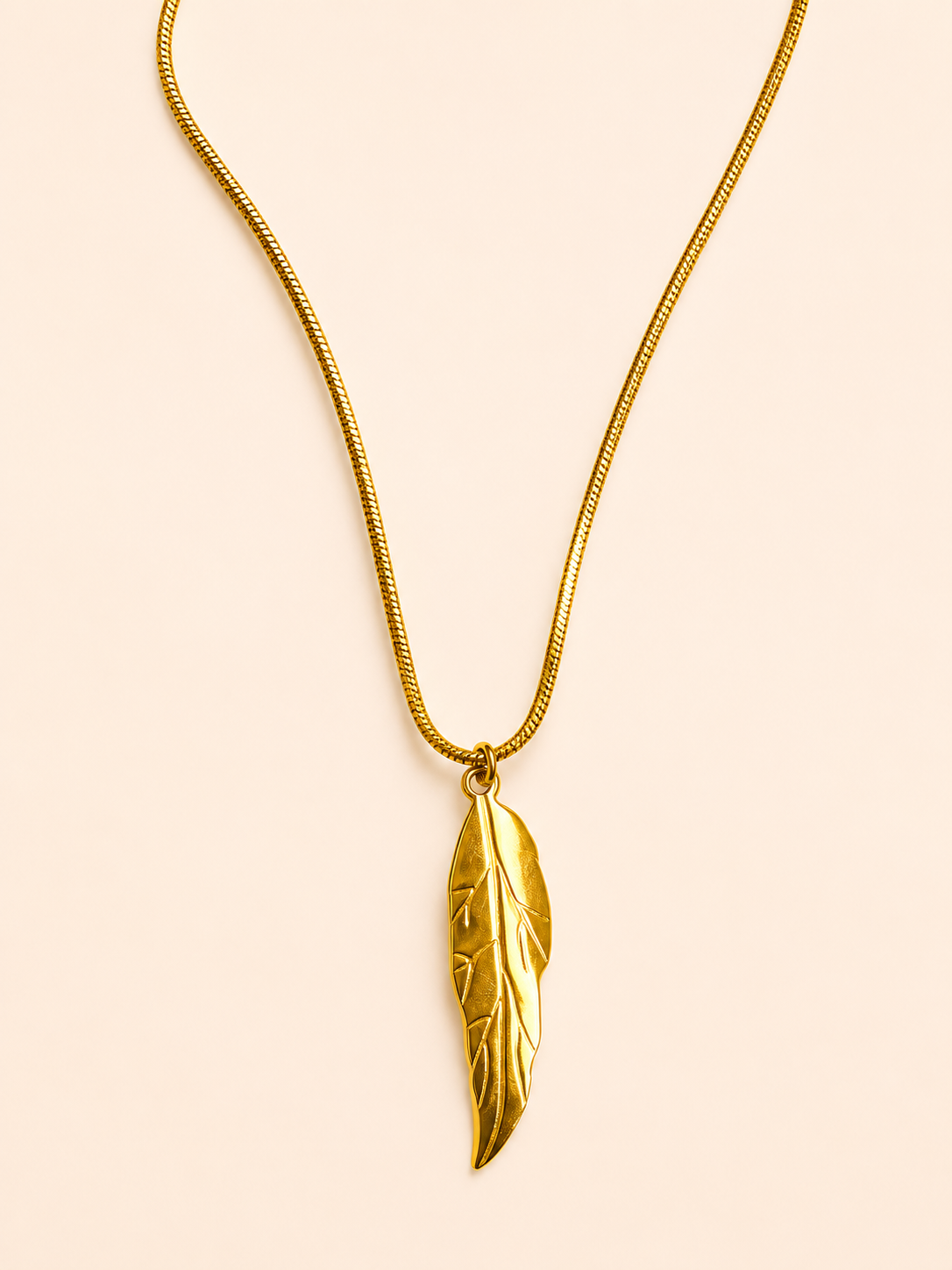 gold stainless steel necklace featuring a delicate leaf-shaped pendant.