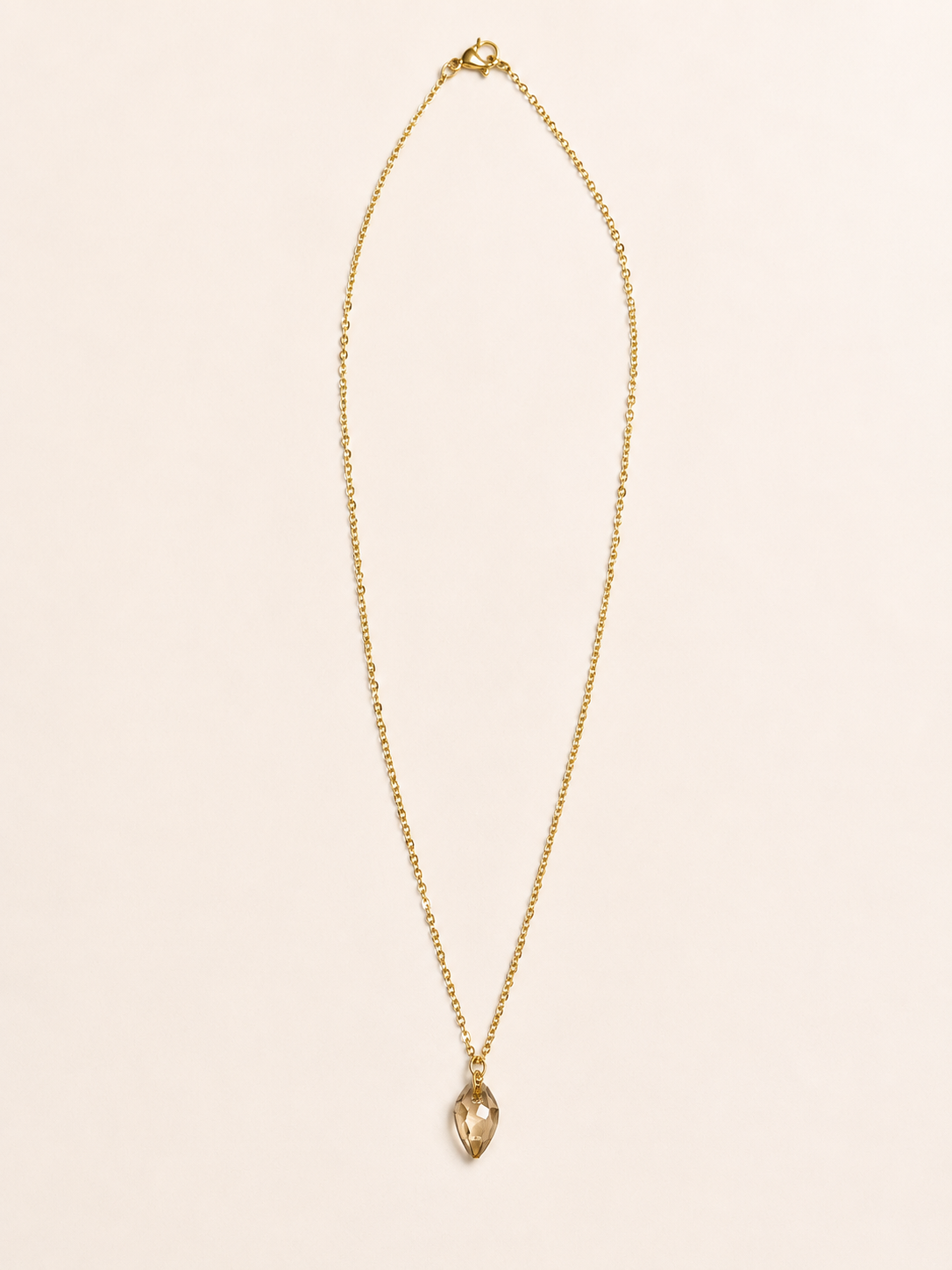 gold stainless steel necklace featuring a luxurious Swarovski crystal in a stunning Shadow Gold shade.